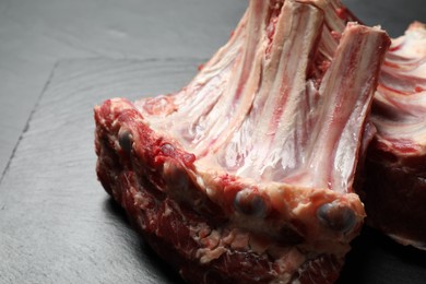 Photo of Raw ribs on slate board, closeup. Fresh meat