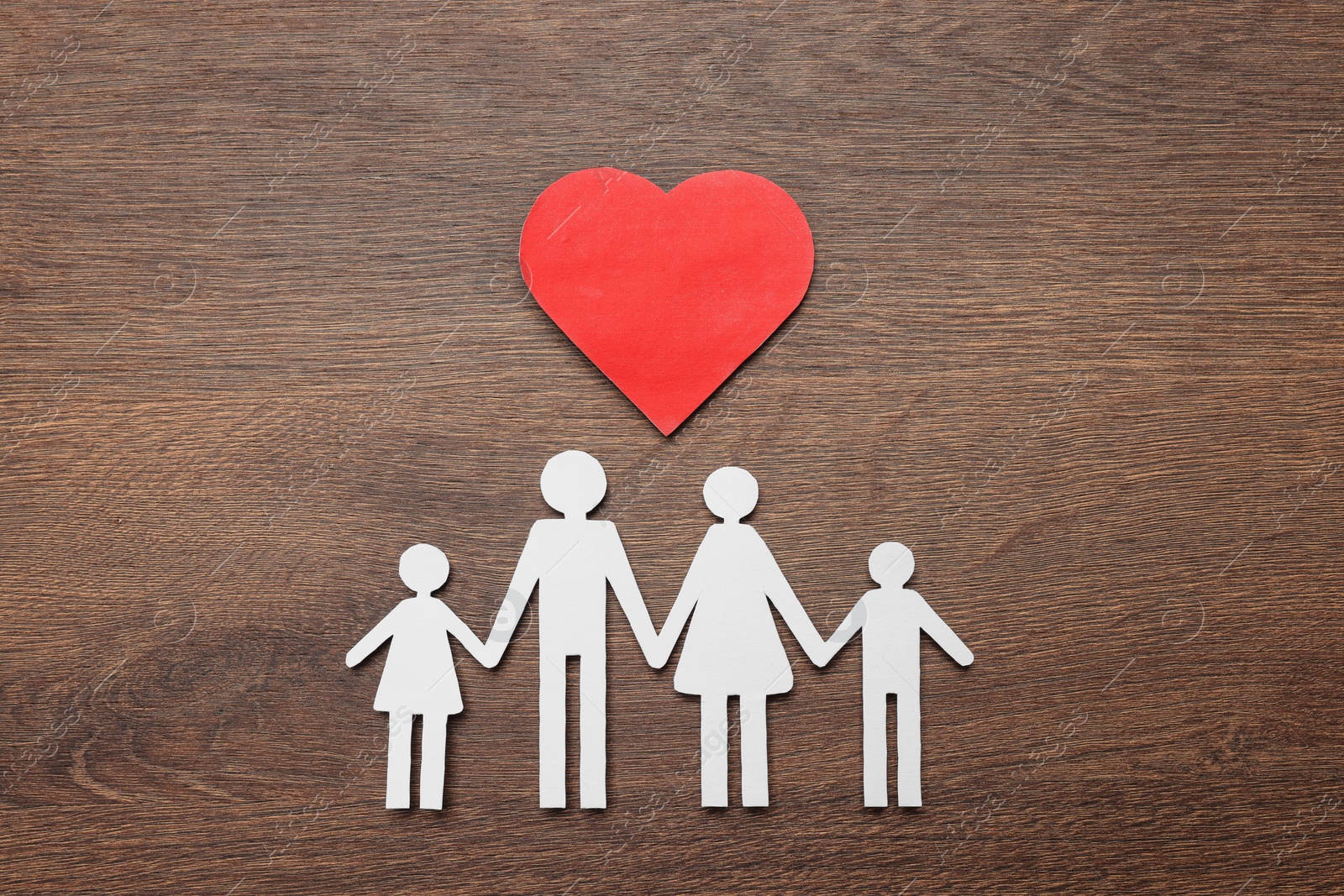 Photo of Paper family cutout and red heart on wooden background, flat lay. Insurance concept