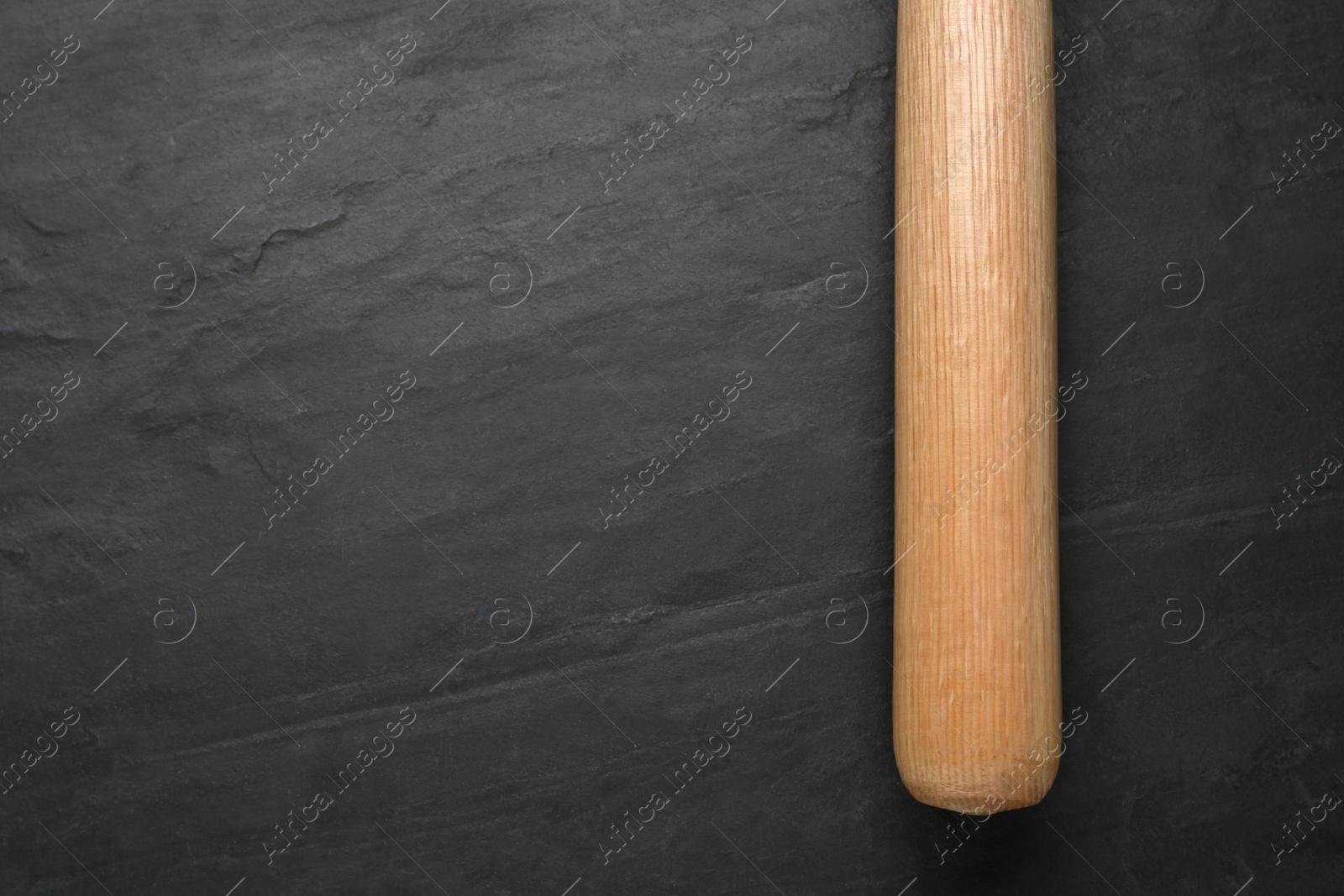 Photo of Baseball bat on black background, top view with space for text. Sports equipment