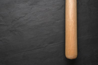 Photo of Baseball bat on black background, top view with space for text. Sports equipment