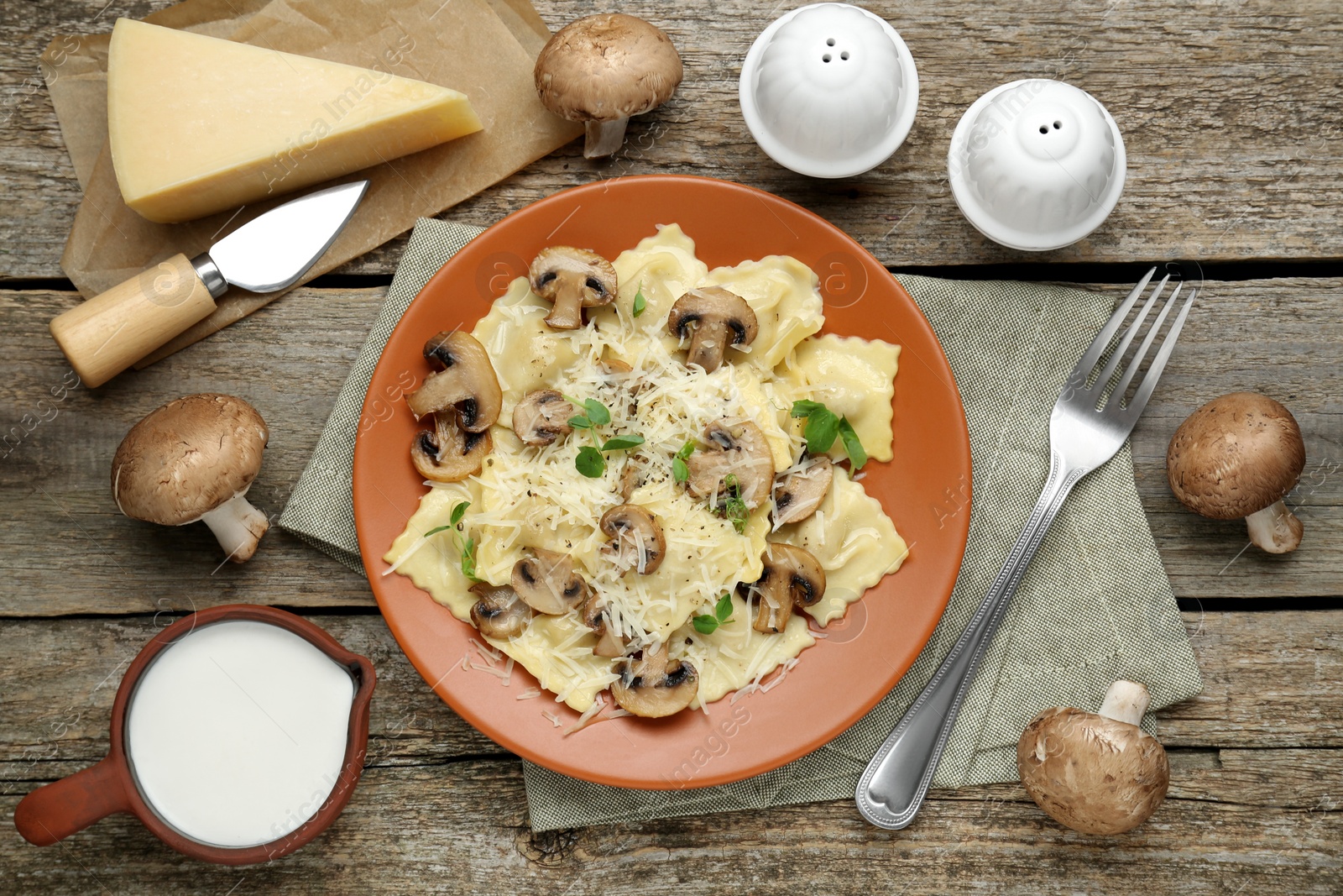 Photo of Delicious ravioli with ingredients on wooden table, flat lay