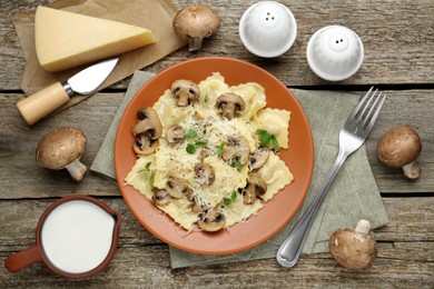 Delicious ravioli with ingredients on wooden table, flat lay