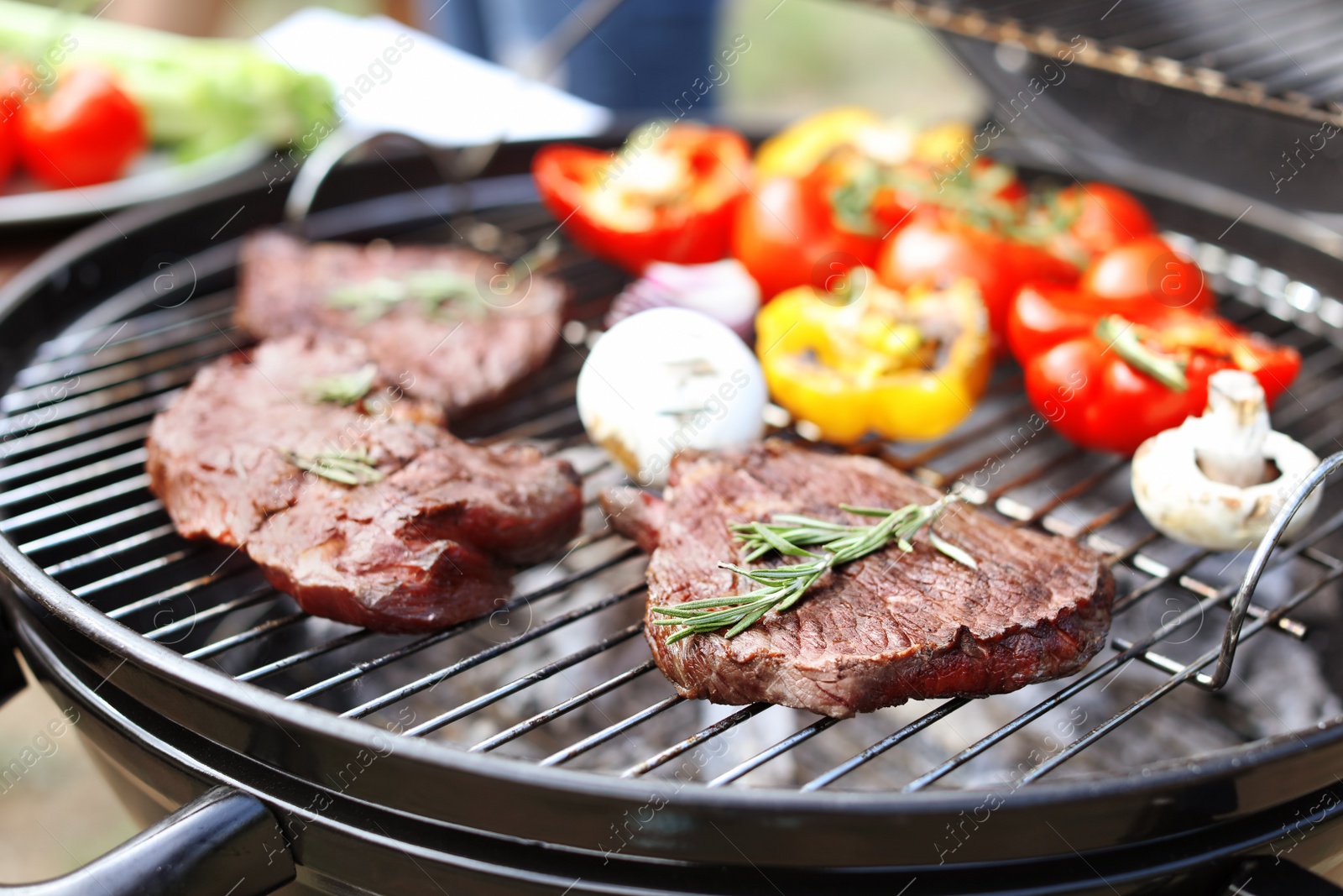 Photo of Modern grill with meat and vegetables outdoors, closeup