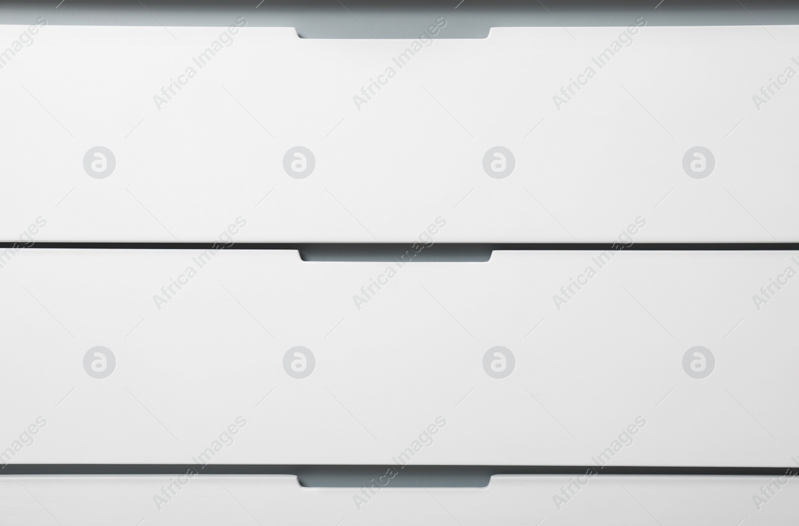 Photo of Modern white chest of drawers as background