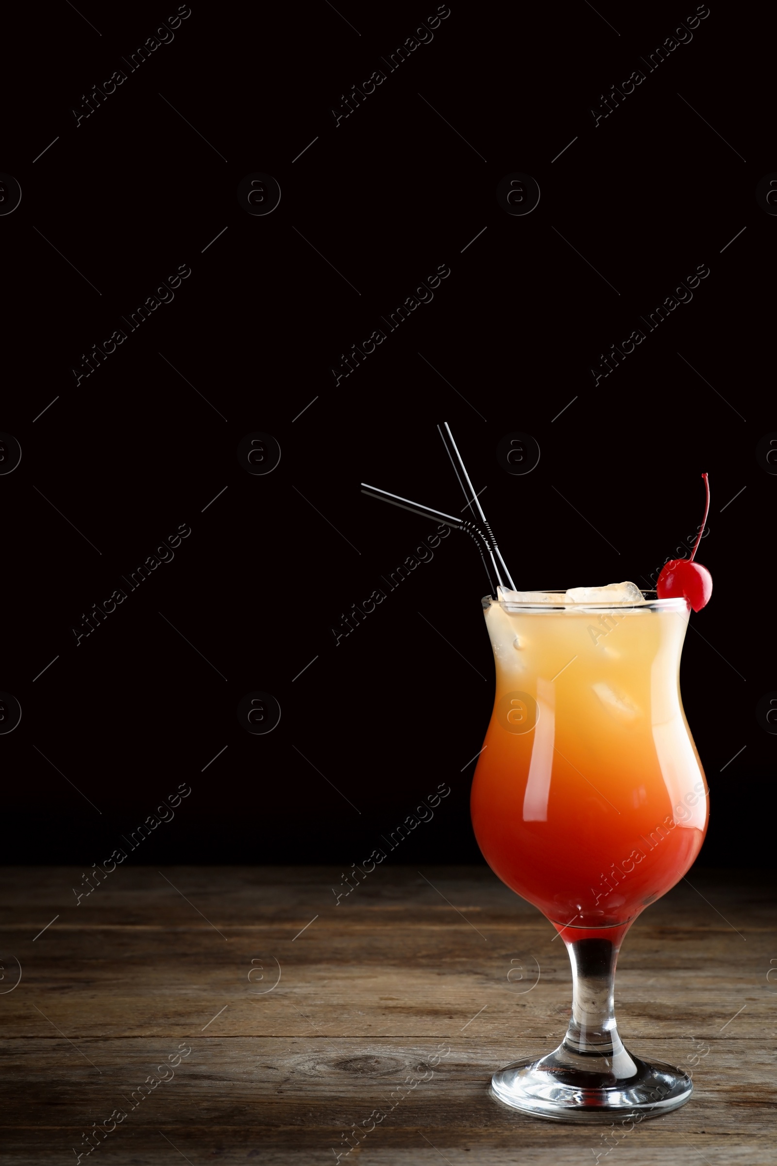 Photo of Just made appetizing cocktail Sex on the Beach, black background. Space for text