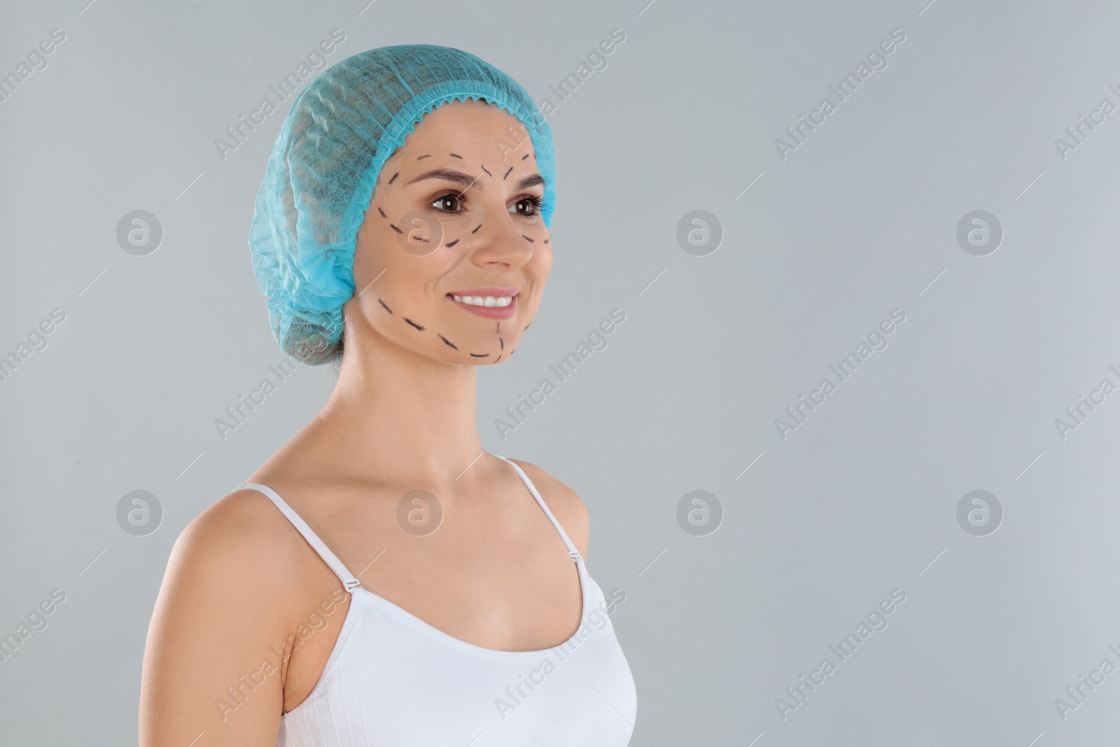 Photo of Portrait of woman with marks on face against grey background, space for text. Cosmetic surgery