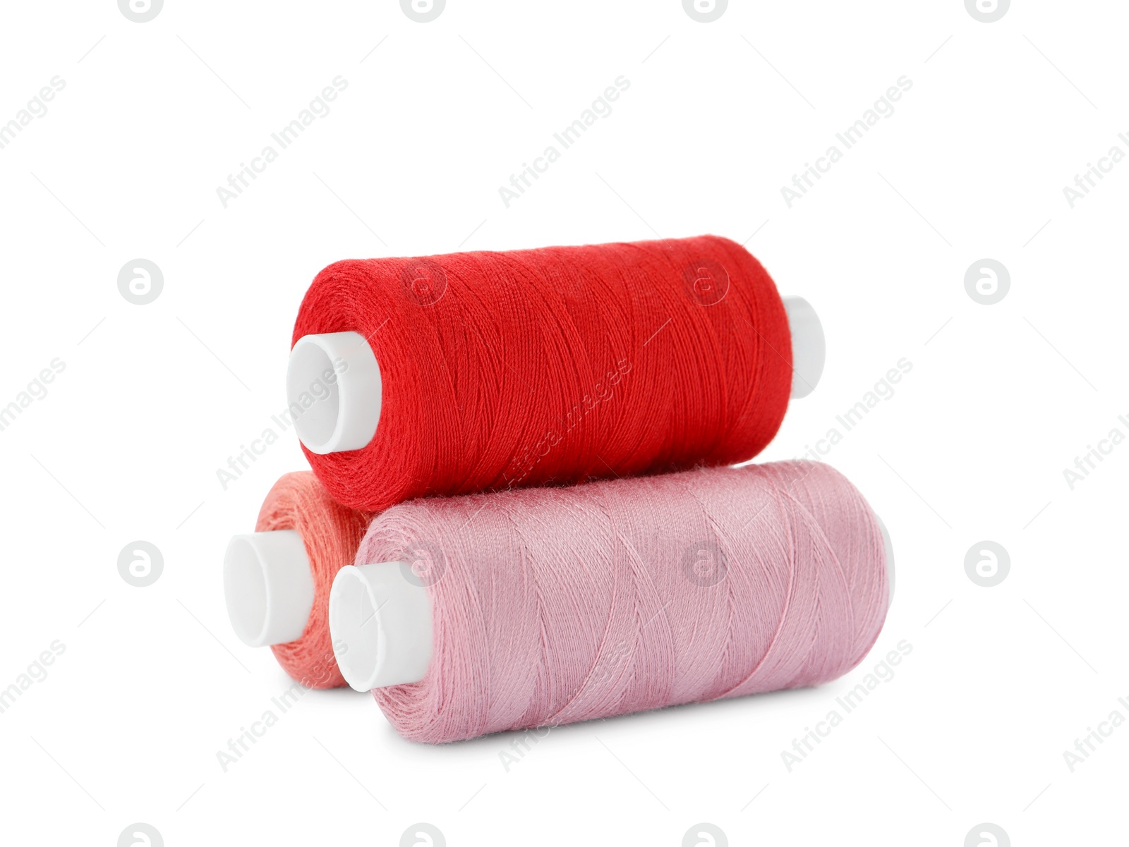 Photo of Different colorful sewing threads on white background