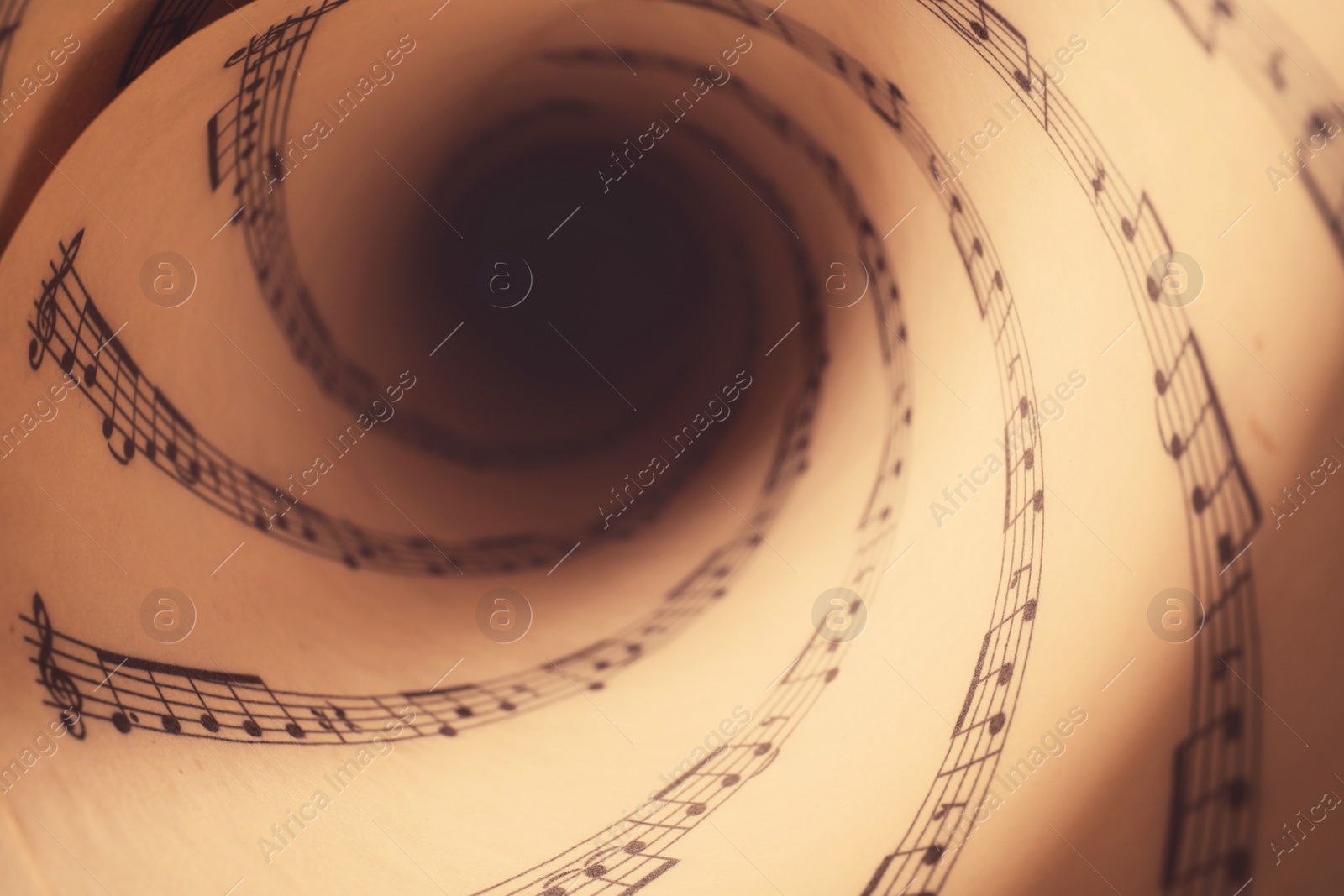 Image of Rolled sheet with music notes as background, closeup