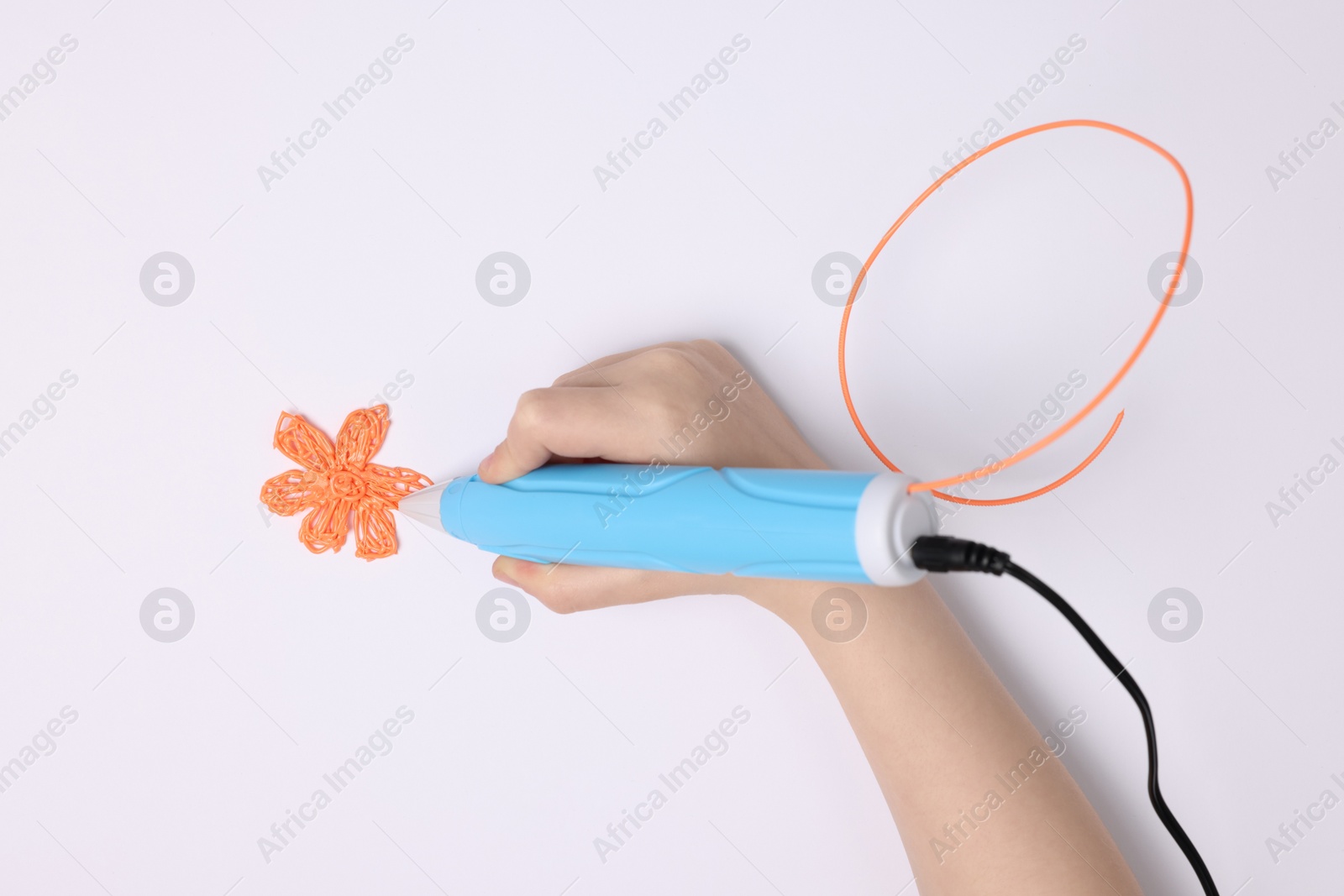 Photo of Boy drawing with stylish 3D pen on white background, top view