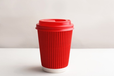 Photo of Takeaway paper coffee cup with lid on white background