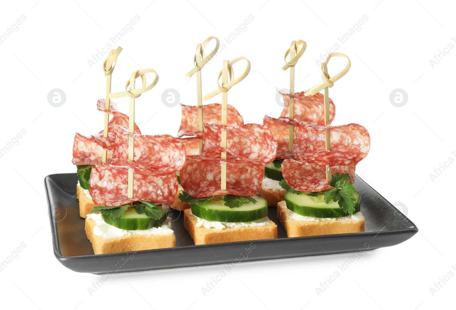 Photo of Tasty canapes with salami, cucumber and cream cheese isolated on white