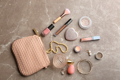 Flat lay composition with perfume, jewelry and cosmetic products on marble table