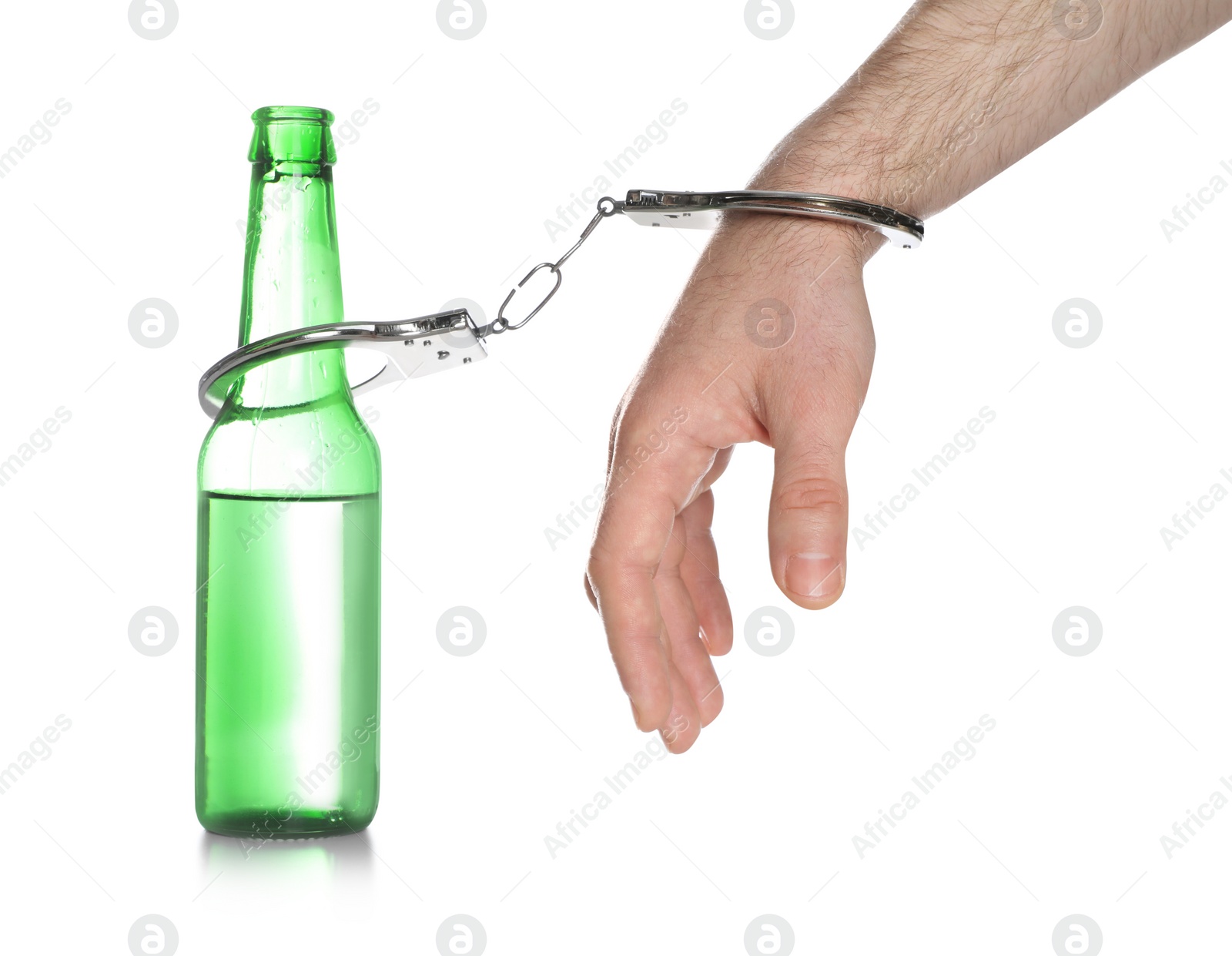 Photo of Man in handcuffs with bottle of beer on white background, closeup. Alcohol addiction