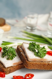 Photo of Plate with pork fatback sandwiches served on table, closeup. Space for text