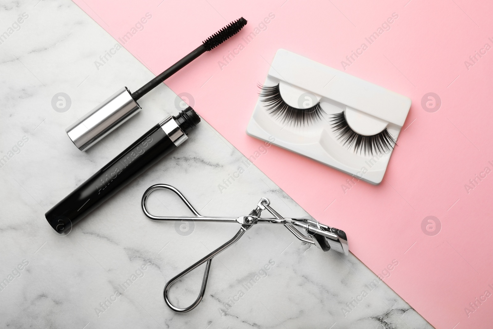 Photo of Artificial eyelashes and accessories on color background, flat lay