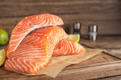Photo of Fresh raw salmon on wooden board. Fish delicacy