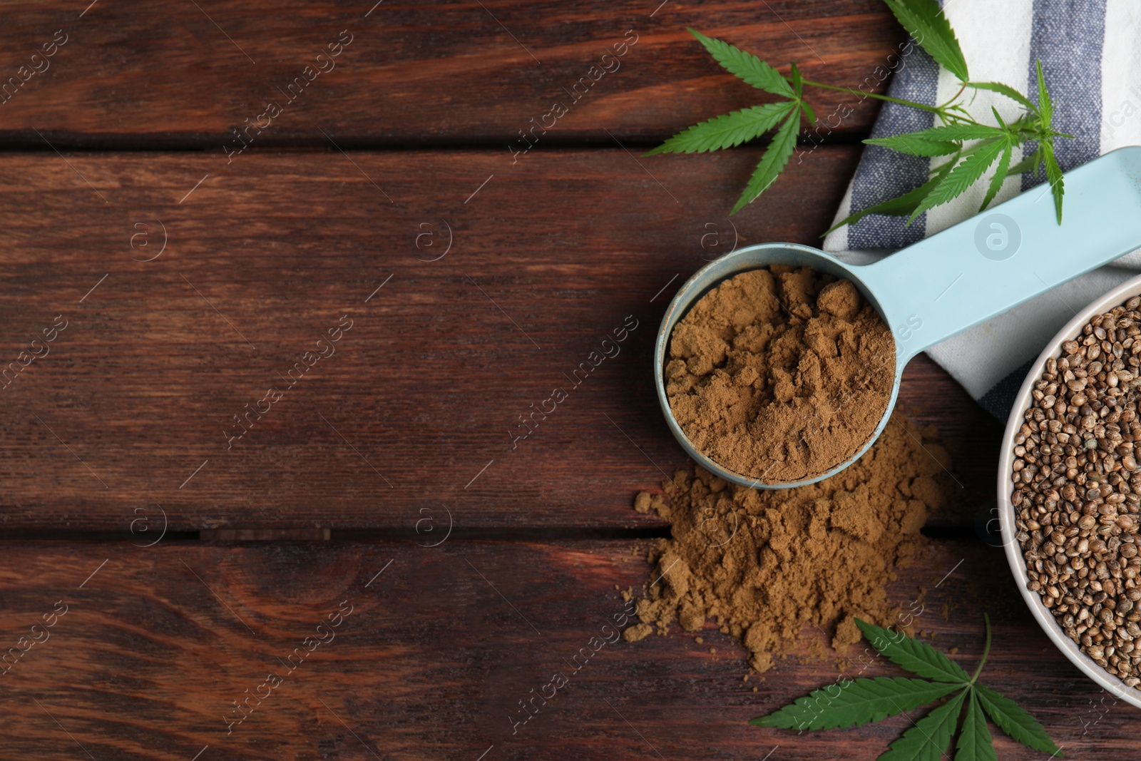 Photo of Hemp protein powder, seeds and fresh leaves on wooden table, flat lay. Space for text