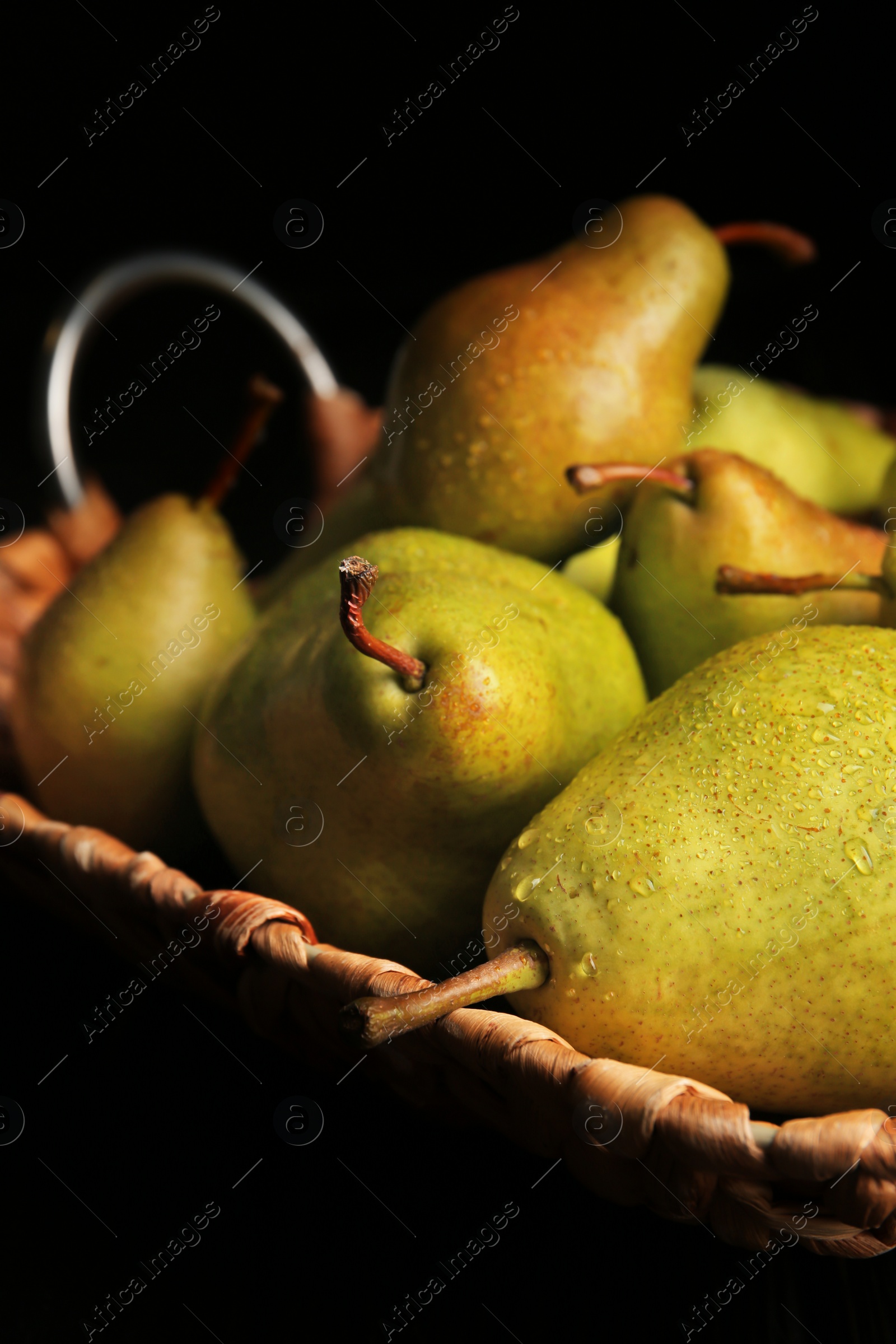 Photo of Tray with ripe pears on dark background, closeup