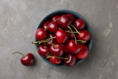 Fresh ripe cherries on grey table, flat lay