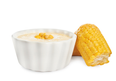 Photo of Delicious corn cream soup and cobs on white background