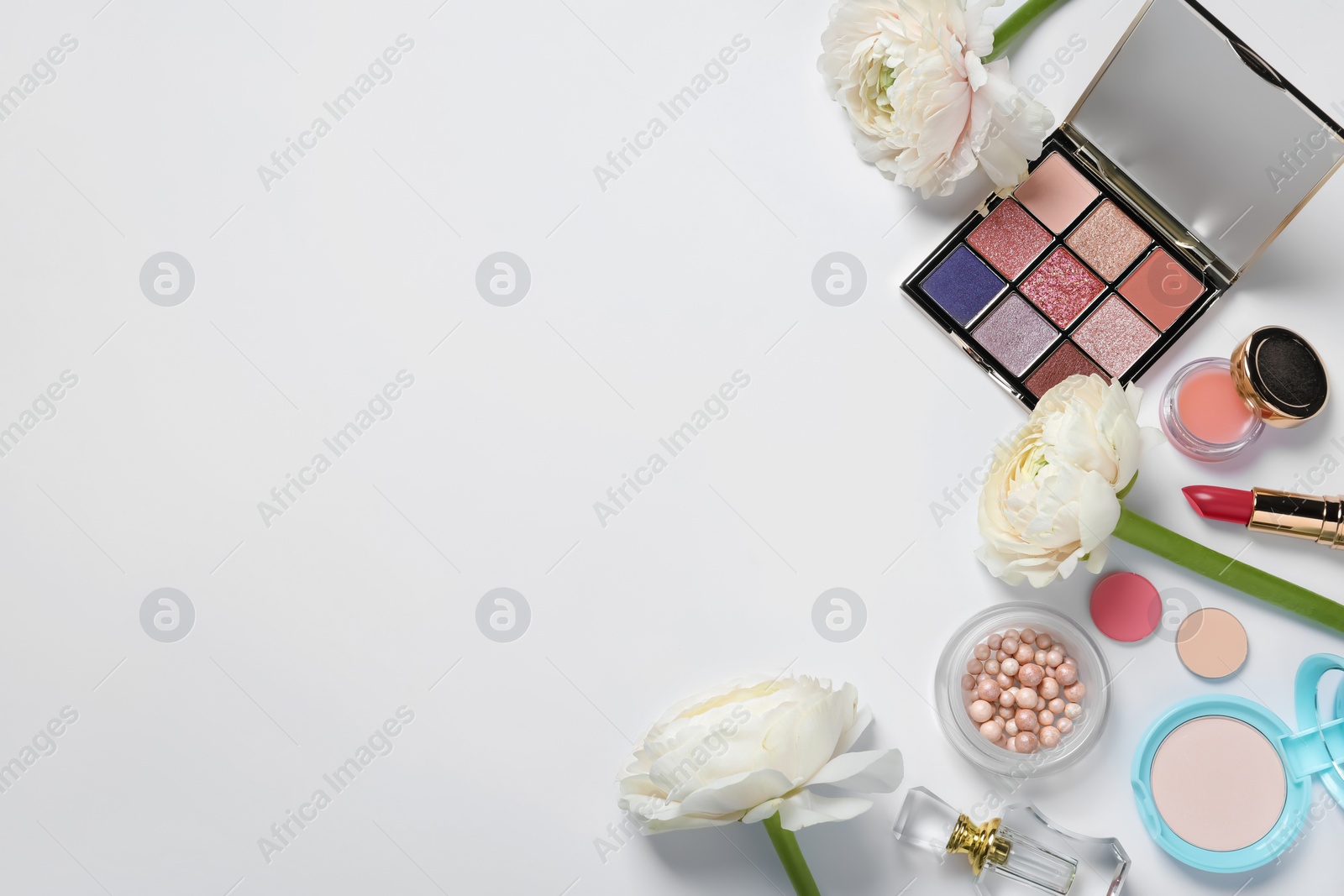 Photo of Flat lay composition with eyeshadow palette and beautiful flowers on white background, space for text