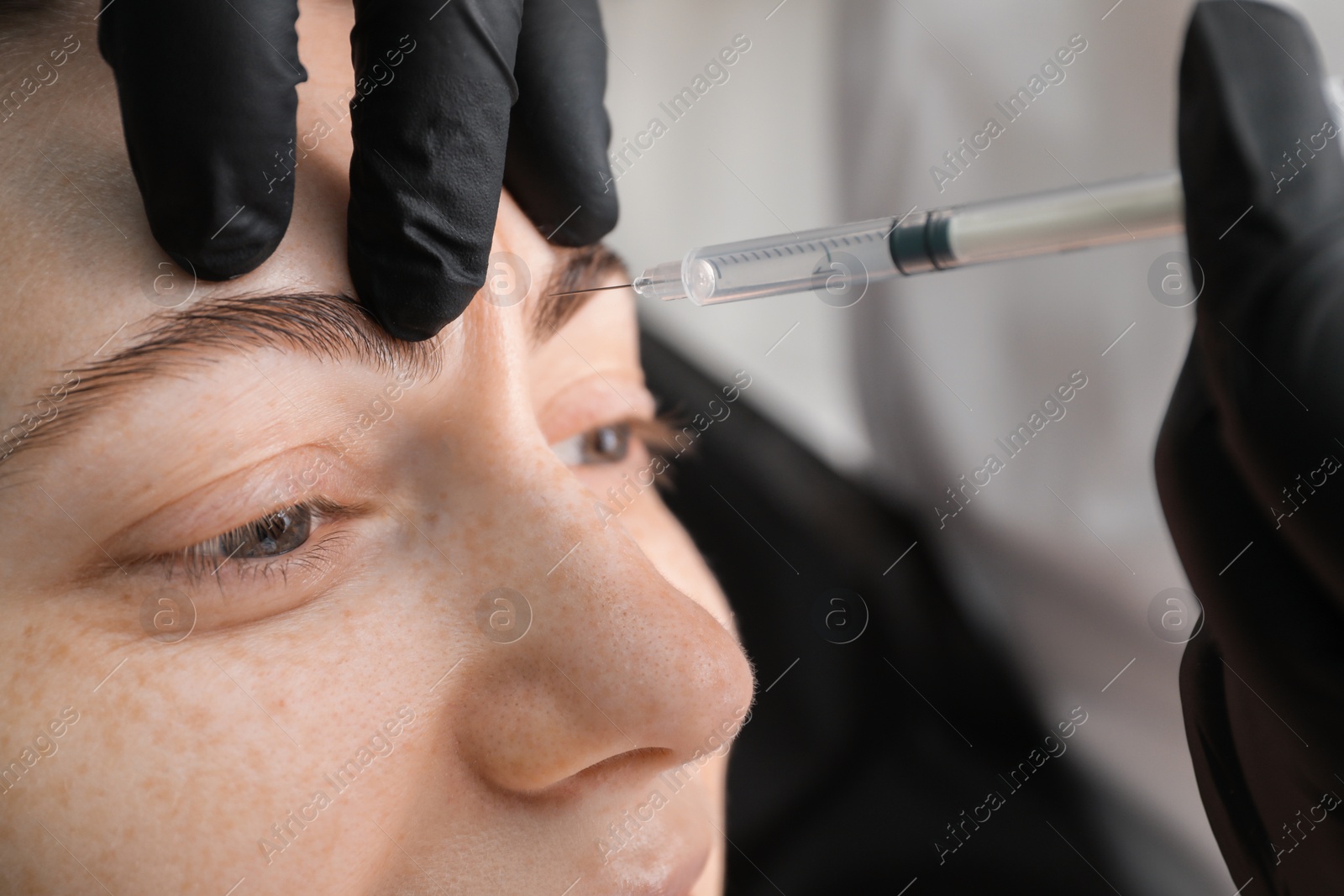 Photo of Cosmetologist giving facial injection to patient, closeup. Cosmetic surgery