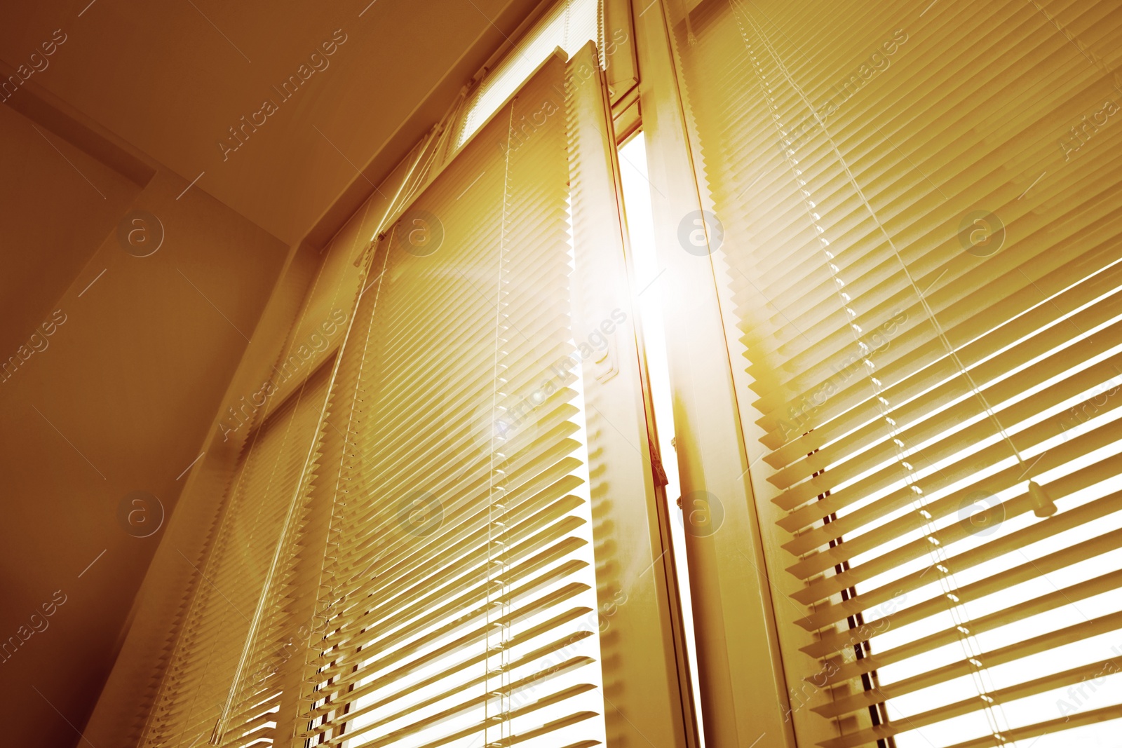 Image of Stylish window with horizontal blinds in room, low angle view