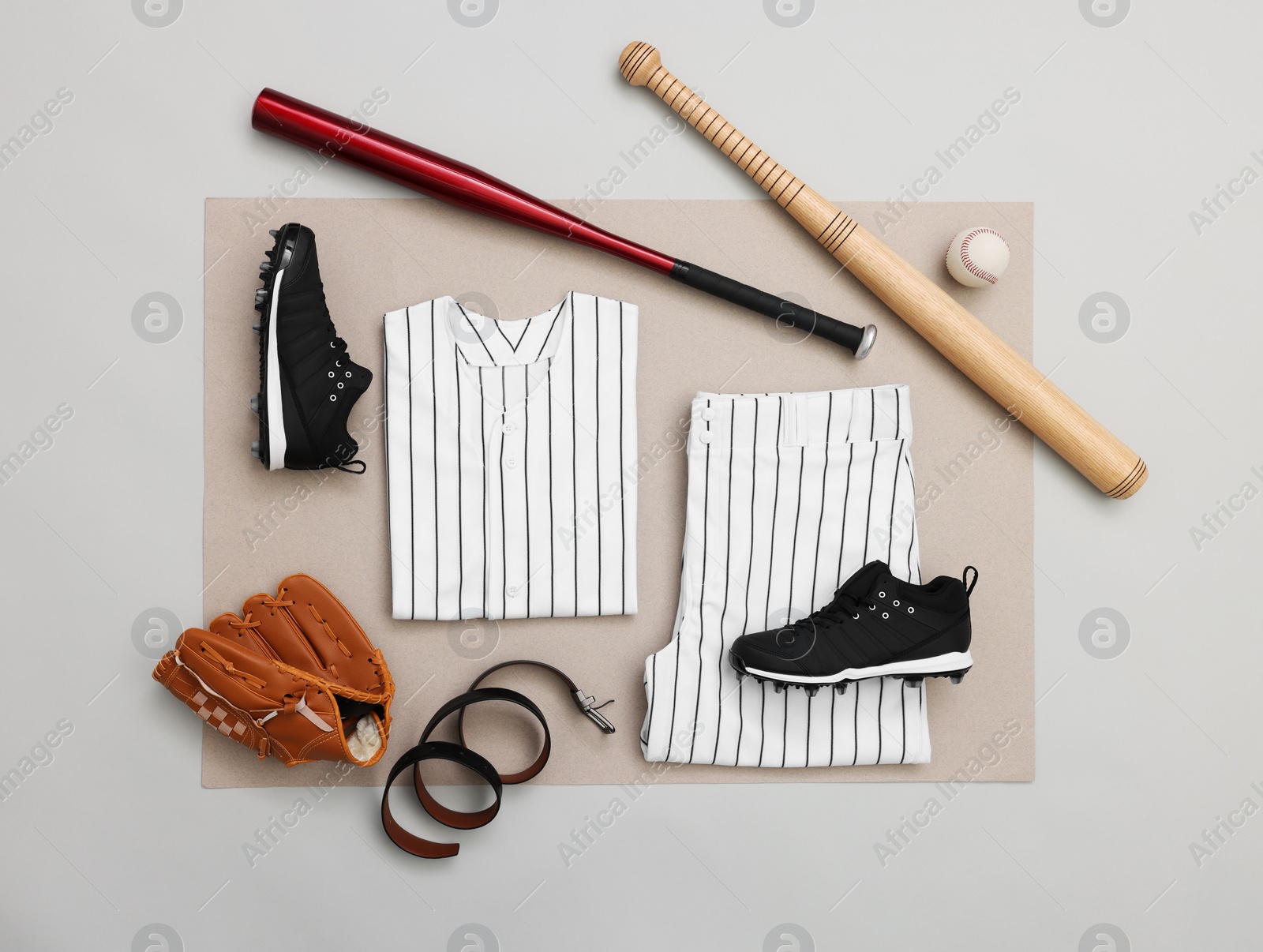 Photo of Flat lay composition with baseball uniform and sports equipment on color background