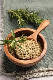 Fresh and dry rosemary on towel, above view
