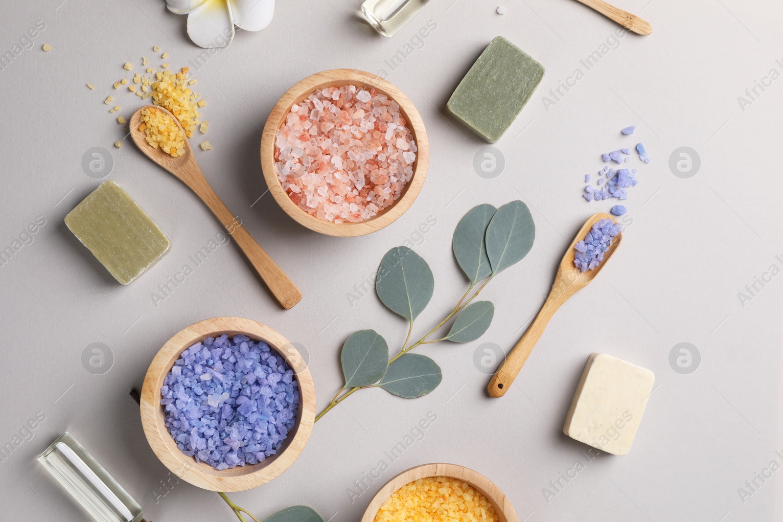 Photo of Flat lay composition with spa products and eucalyptus branches on grey background