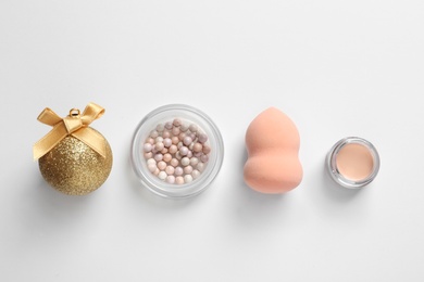 Photo of Flat lay composition with makeup products and Christmas decor on white background