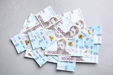 Photo of Ukrainian money on grey background, flat lay
