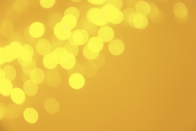 Blurred view of shiny gold lights. Bokeh effect