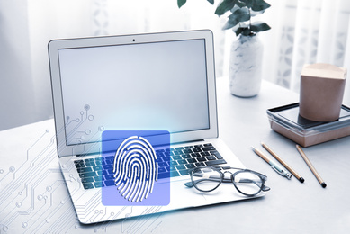 Fingerprint identification. Modern laptop on table indoors