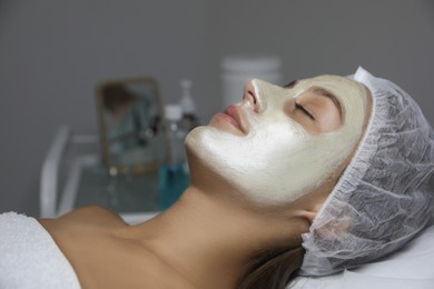 Photo of Beautiful woman with mask on her face in spa salon