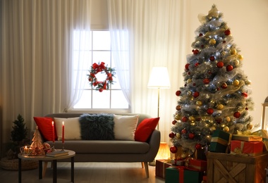 Image of Beautiful Christmas tree in living room. Festive interior