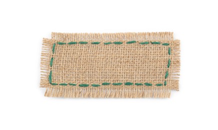 Piece of burlap fabric with green stitches isolated on white, top view