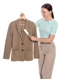 Photo of Young woman cleaning suit with lint roller on white background