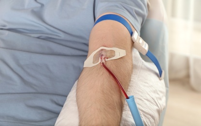 Man donating blood to save someone's life in hospital