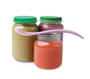 Photo of Glass jars with healthy baby food and spoon isolated on white