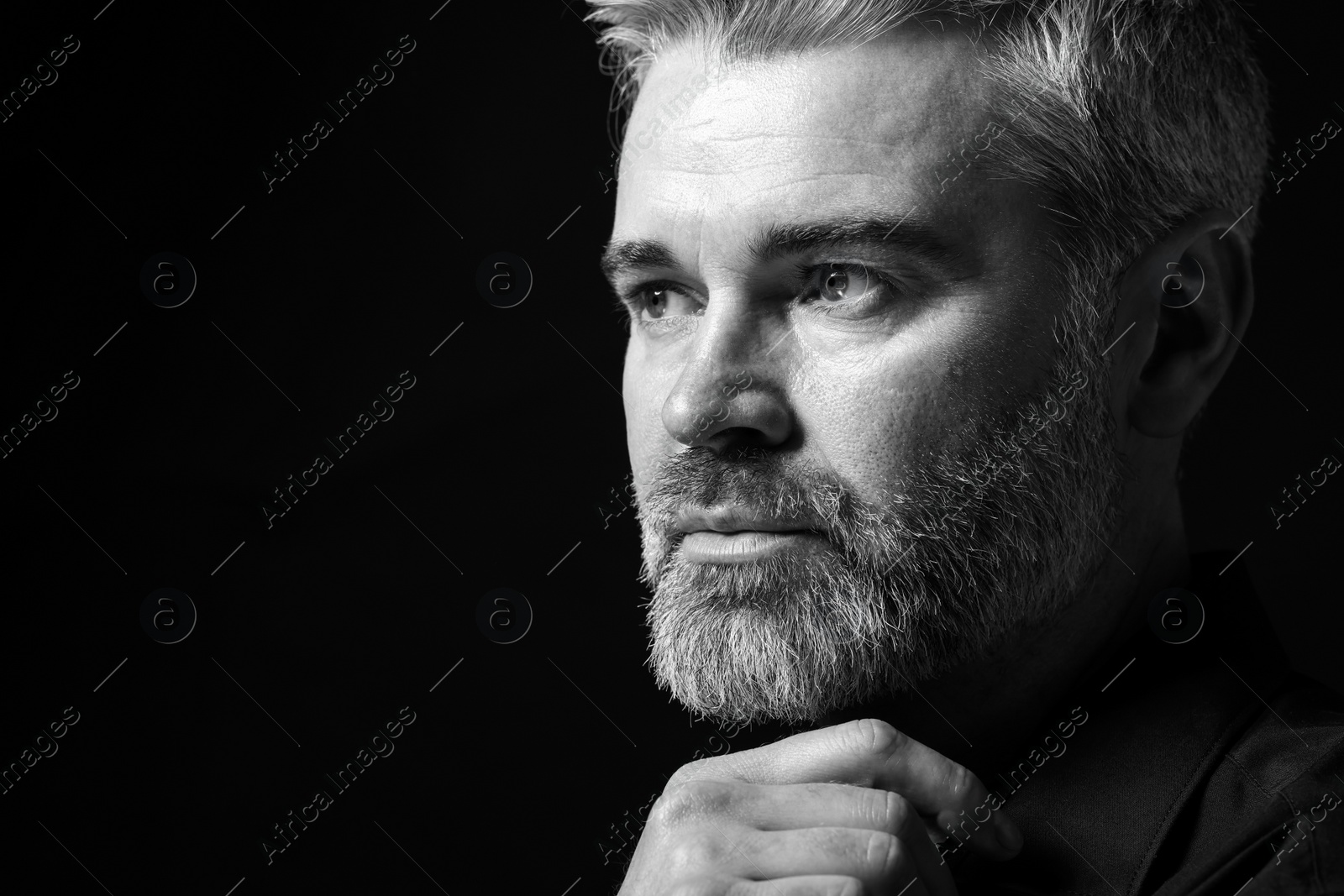 Photo of Portrait of handsome man on dark background, space for text. Black and white effect