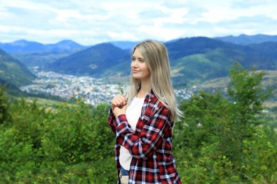 Photo of Woman enjoying beautiful mountain landscape at summer