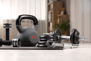 Photo of Many different sports equipment on floor indoors