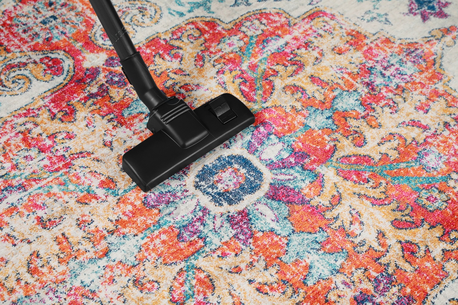 Photo of Removing dirt from carpet with modern vacuum cleaner. Space for text