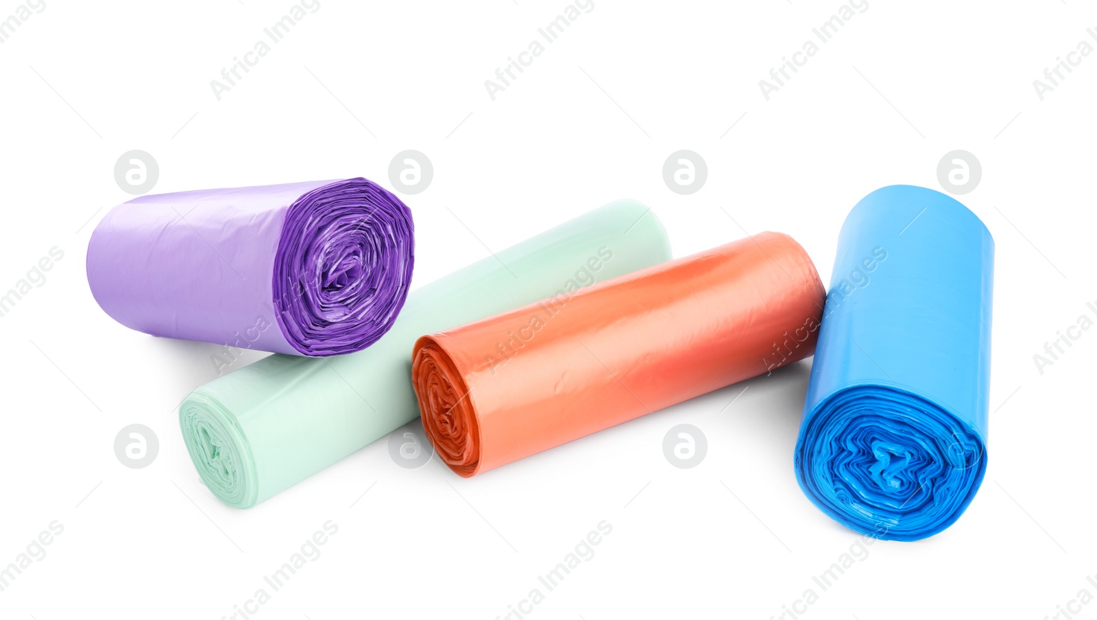 Photo of Rolls of different color garbage bags isolated on white