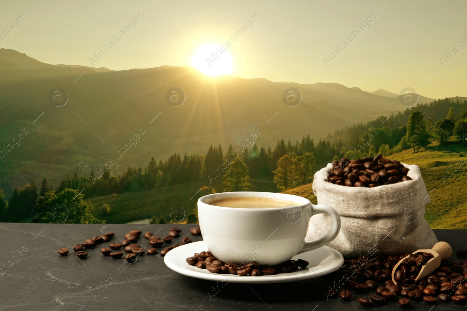 Image of Cup of aromatic hot coffee on black table and beautiful view of mountain landscape. Space for text