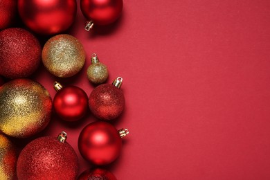 Christmas balls on red background, top view. Space for text