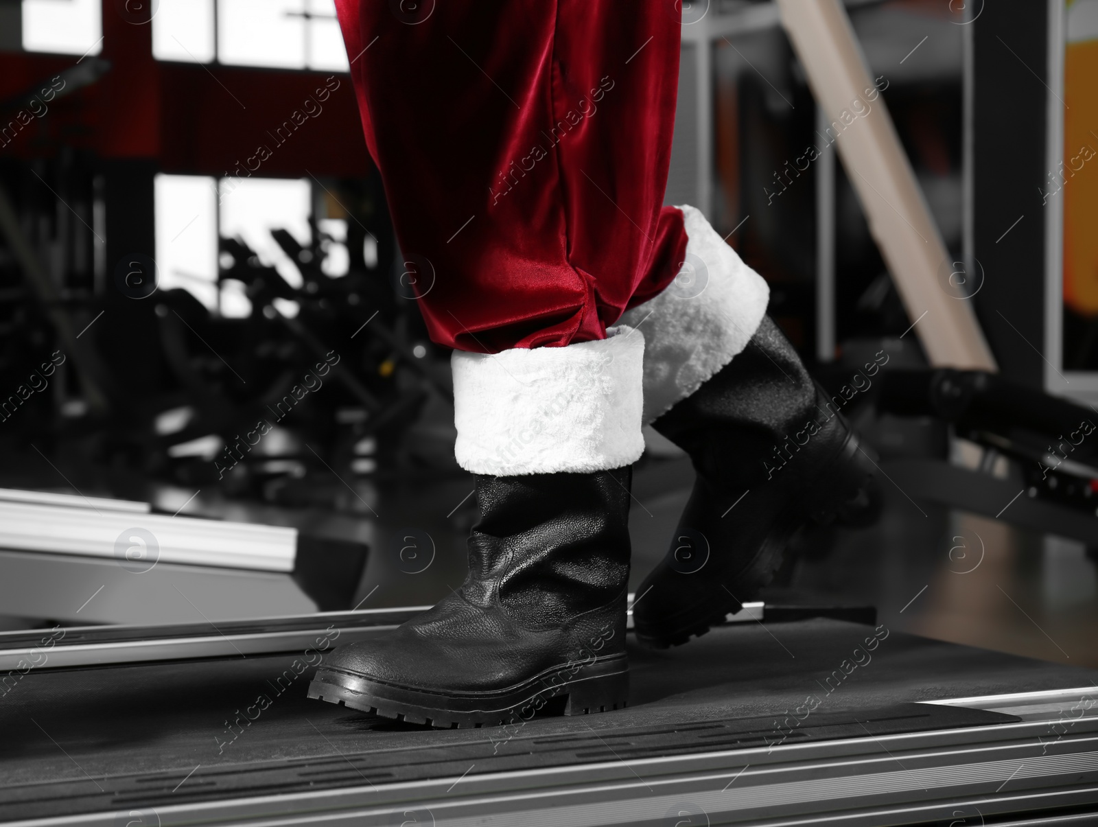 Photo of Authentic Santa Claus training on treadmill in modern gym, closeup