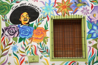 Photo of San Pedro Garza Garcia, Mexico – February 8, 2023: Building with beautiful traditional street art and window