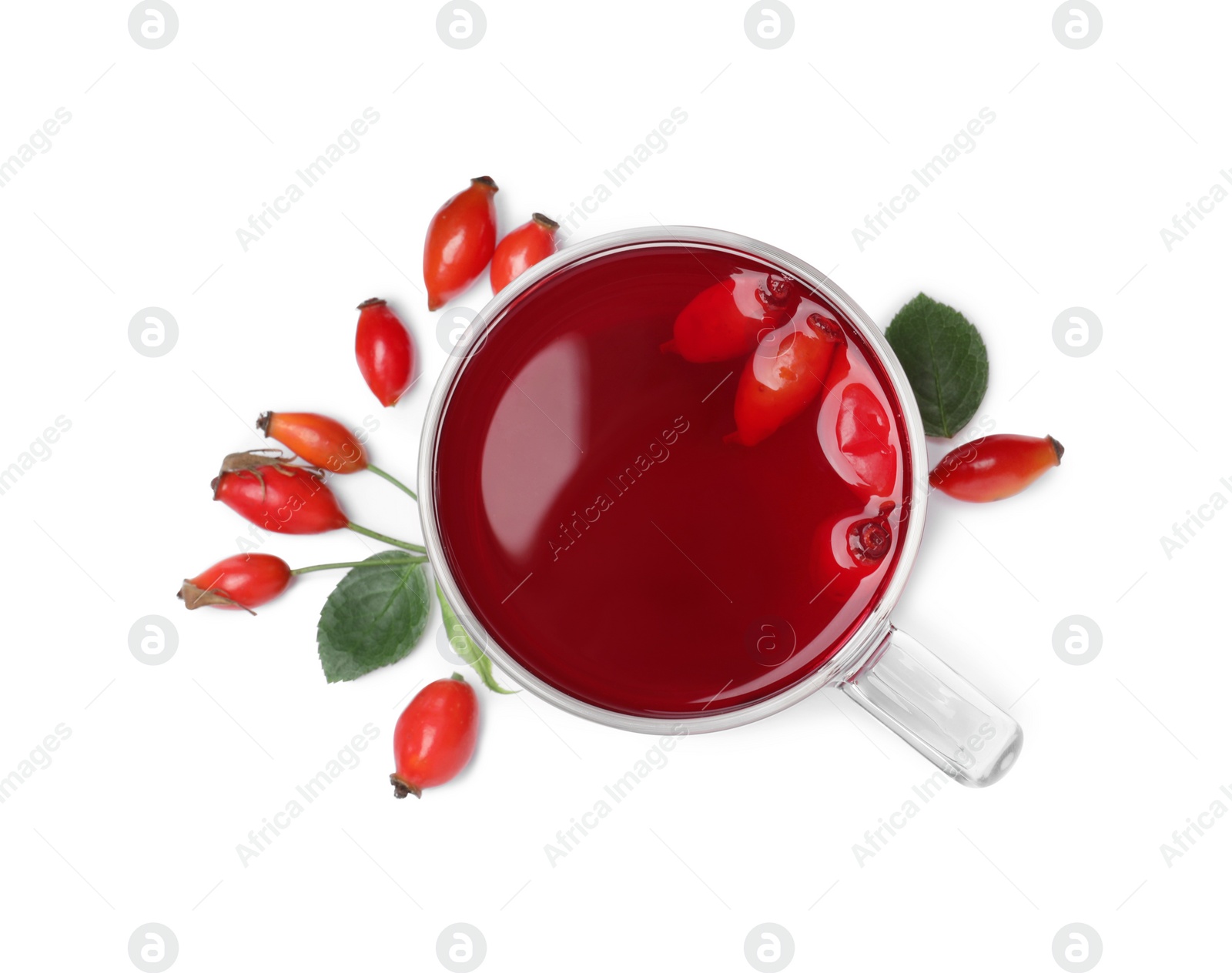 Photo of Aromatic rose hip tea and fresh berries on white background, top view